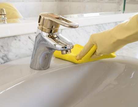Cleaner servicing a built-in oven in a Marylebone apartment
